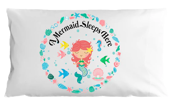 Pillow case with mermaid design and 'A Mermaid Sleeps Here' text on a white background