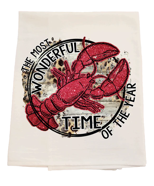 Tea towel with red lobster design and text 'The Most Wonderful Time of the Year' on a white background