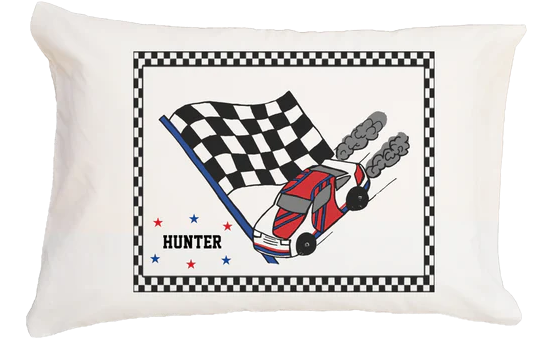 Pillow with race car and checkered flag design on a white background