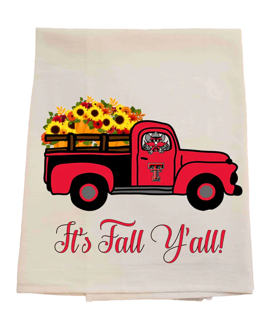 Tea towel with a red truck carrying flowers and 'It's Fall Y'all!' text on a white background