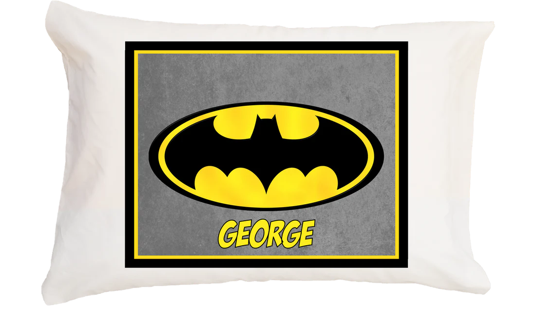 Pillow with Batman logo and name 'George' on a gray background