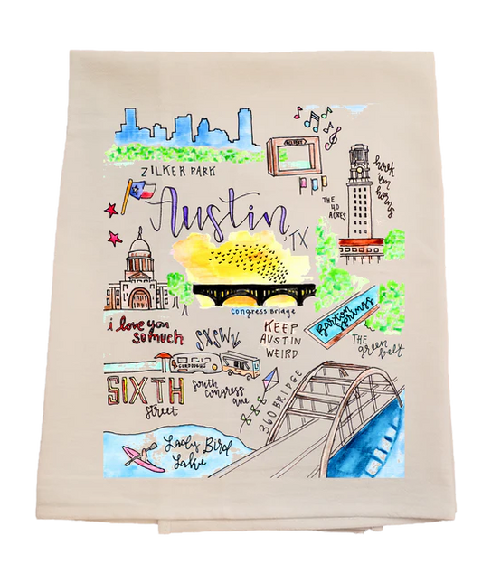 Beige towel with colorful illustrations of Austin landmarks and text on a white background