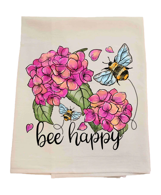 Floral towel with pink flowers, bees, and 'bee happy' text on a white background