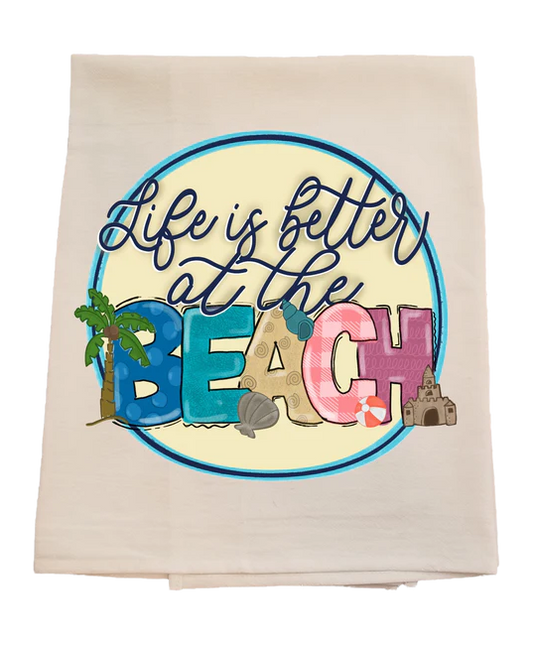 Beach-themed towel with 'Life is better at the Beach' text and beach elements.
