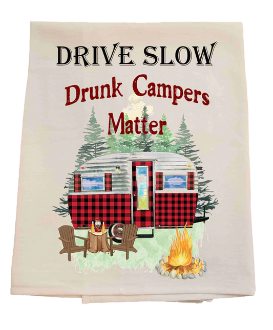 Tea towel with a campervan, chairs, and bonfire design, featuring the text 'Drive Slow Drunk Campers Matter'.