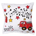Decorative pillow with a red fire truck, black cat, and musical notes design on a white background.