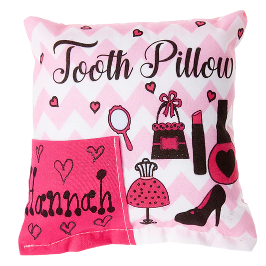 Decorative pillow with 'Tooth Pillow Hannah' text and fashion-themed illustrations on a pink and white chevron background.