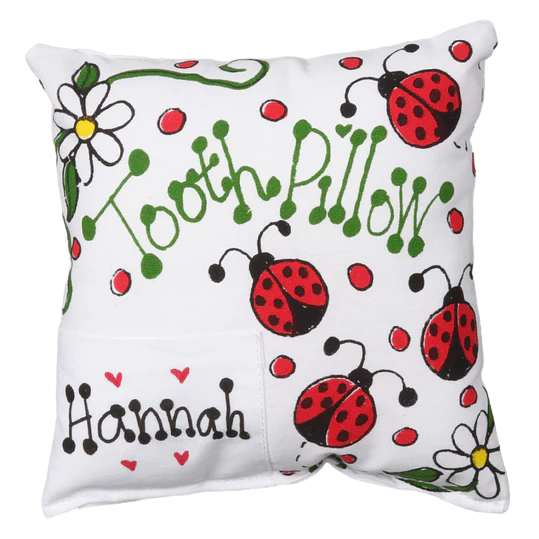 Tooth pillow with ladybug and flower patterns on a white background