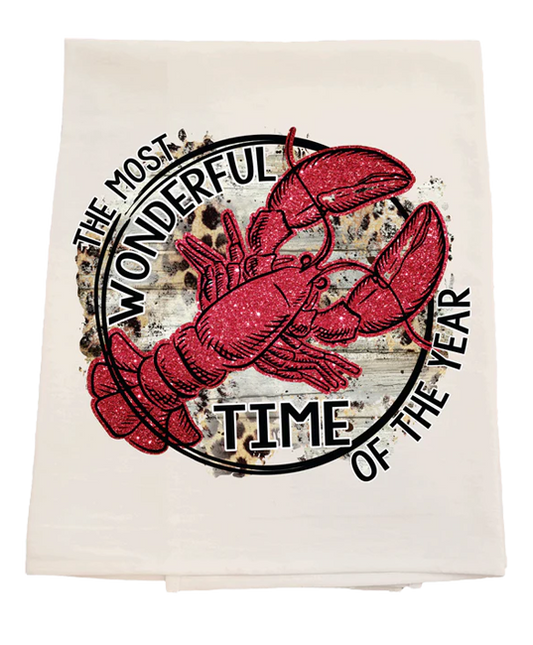 Tea towel with red lobster design and text 'The Most Wonderful Time of the Year' on a white background