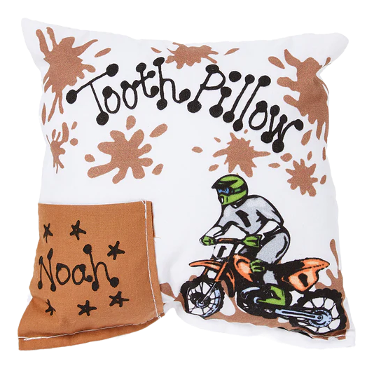 Pillow with 'Tooth Pillow' text, brown splashes, and a cartoon character on a bike.