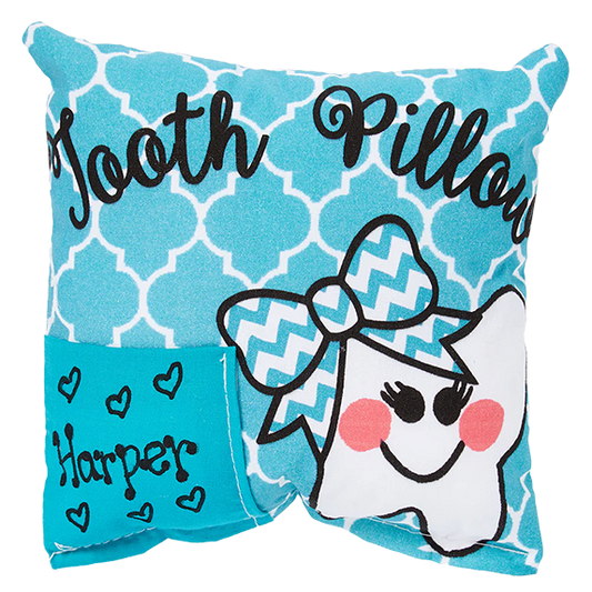 Teal tooth pillow with cartoon tooth and name 'Harper' on a white background