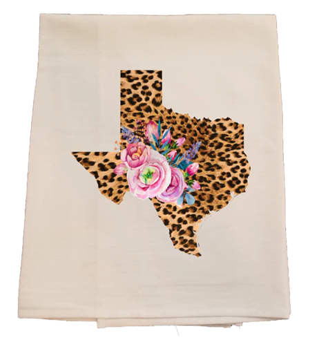Beige towel with a leopard print Texas shape and floral design on a white background