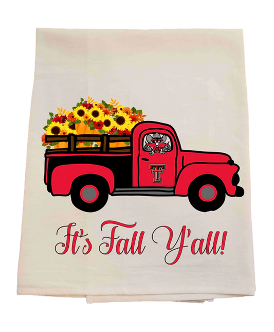 Tea towel with a red truck carrying flowers and 'It's Fall Y'all!' text on a white background