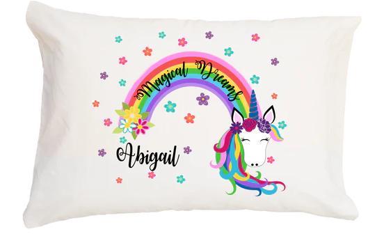 Pillow with unicorn design, rainbow, and 'Magical Dreams Abigail' text on a white background