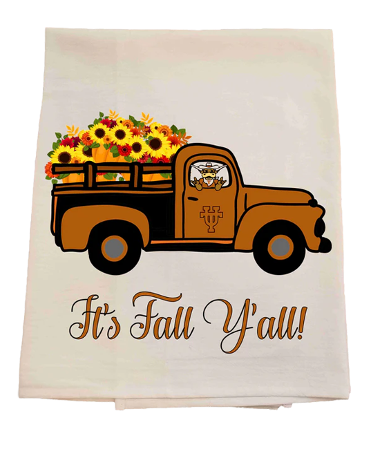 Tea towel with an orange truck carrying fall flowers and 'It's Fall Y'all!' text on a white background