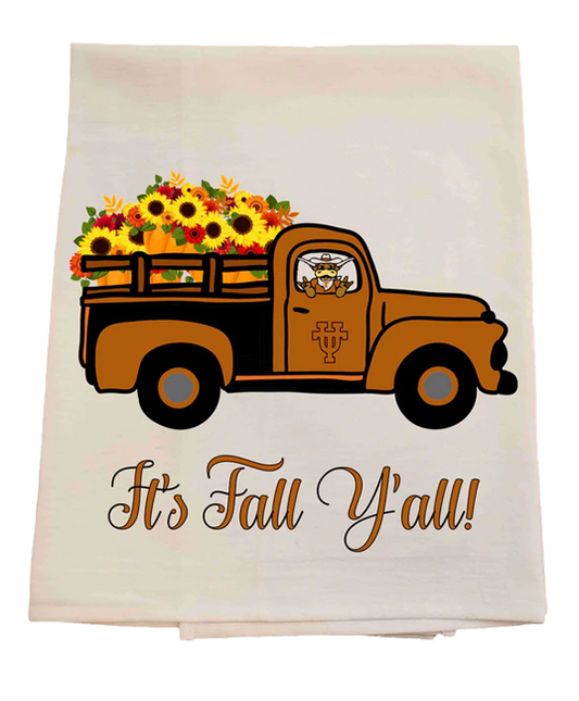 Tea towel with an orange truck carrying fall flowers and 'It's Fall Y'all!' text on a white background