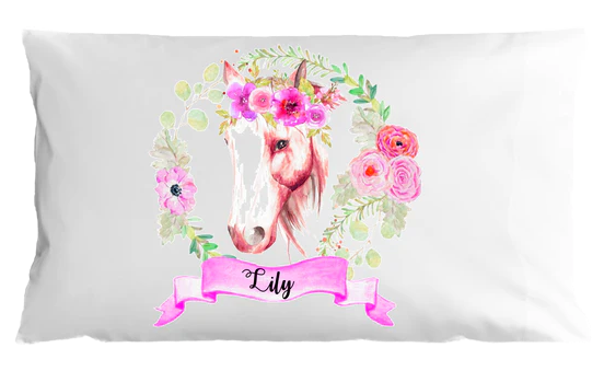 Pillow case with a unicorn design and floral elements on a white background